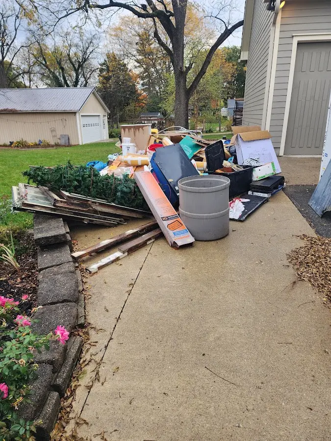 Dumpster being loaded with debris for 12 Yard Dumpster Rental in Crossville